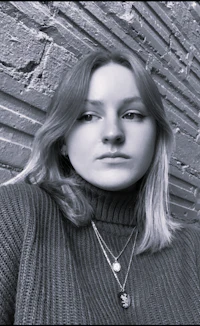 a black and white photo of a woman in a turtleneck sweater